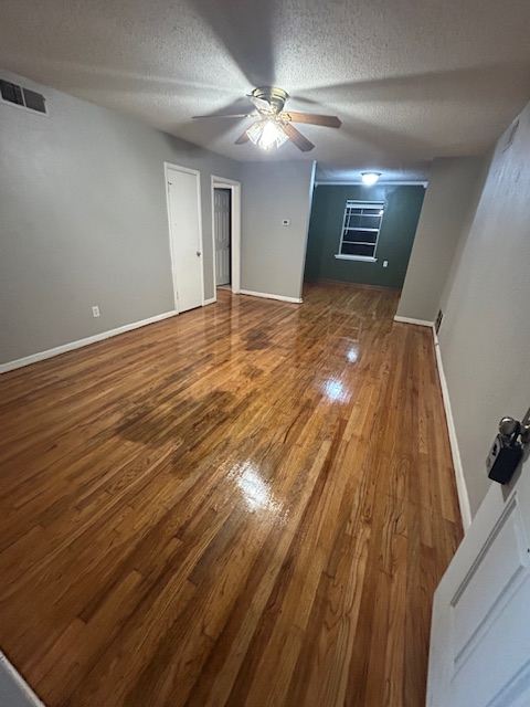 Refinished hardwood floors in a living room in Lawton Oklahoma by VCV Services